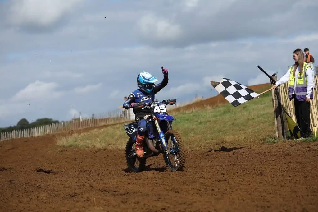 Harley Pastoor celebrating as he passes the chequered flag