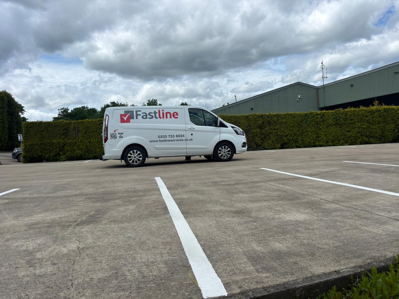 A freshly line-marked car park with crisp white parking bay markings by Fastline Services
